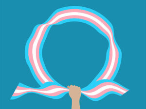 Imagem de uma mão a agarrar uma faixa em circulo com as cores da bandeira trans 