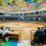 sala com pessoas sentadas em mesa redonda