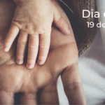 mão de homem virada para cima, apoia mão de bebé. dia do pai. 19 de março